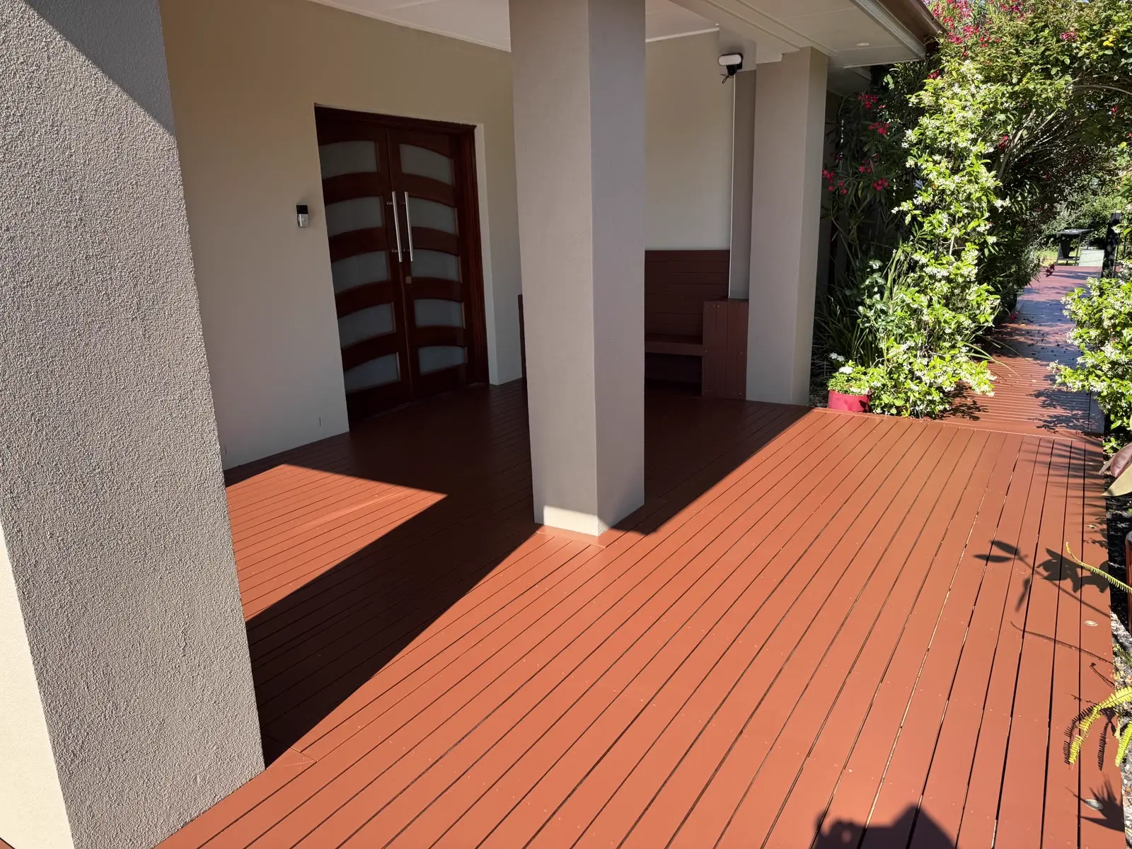 Richly stained timber deck and entry portico completed by Freshy Painting Melbourne