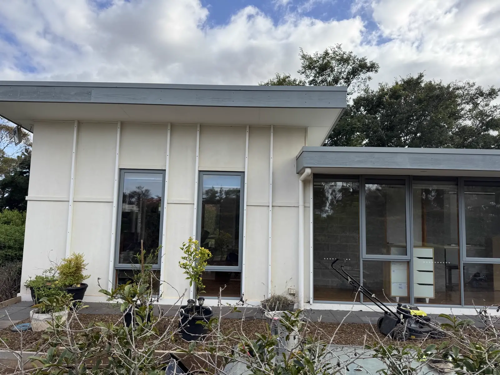 Freshly painted modern rendered home exterior with charcoal window frames in Melbourne