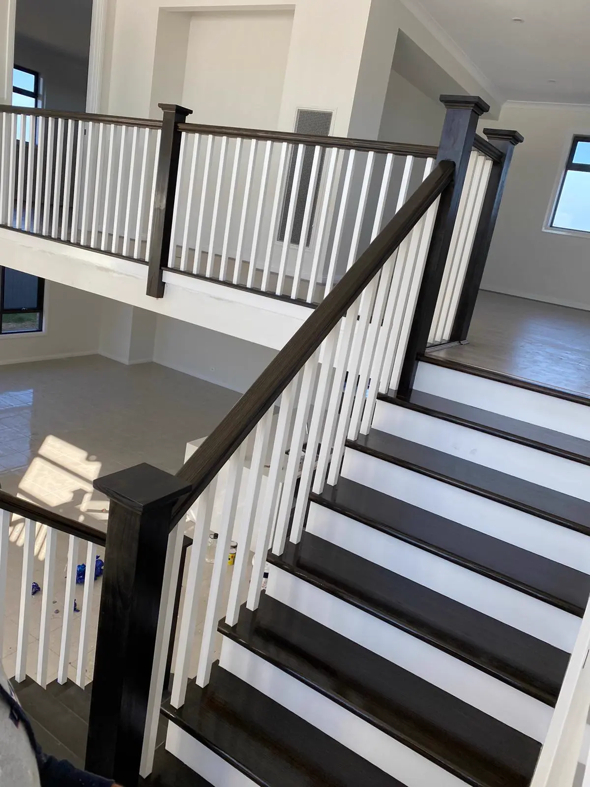 High stairwell void with freshly painted walls and white balustrade