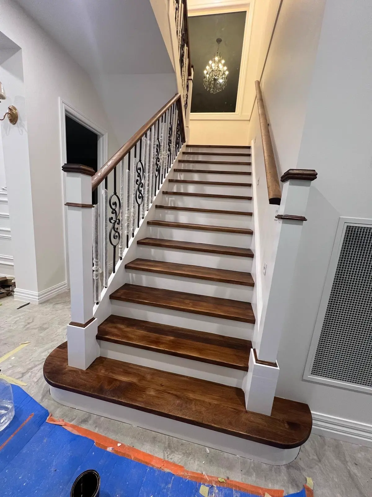 Painted stairwell with white balustrade and stained timber treads in a Melbourne home